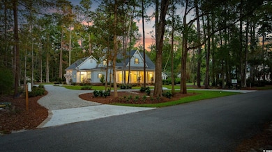 Modern farmhouse style home with curved driveway, a yard, and a porch