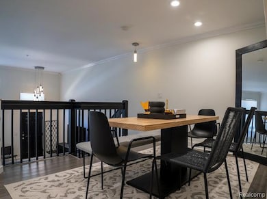 Dining area featuring ornamental molding, wood finished floors, and recessed lighting