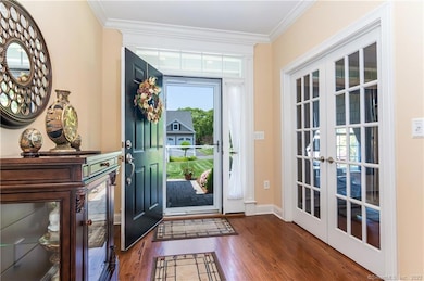 Upon entering, you will note the transom window over the front door, which adds brightness to the foyer.