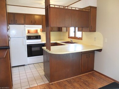 Fully applianced kitchen with tile floor and break