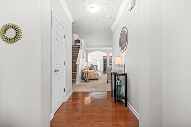 Corridor with a textured ceiling, arched walkways,