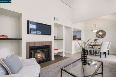 View from living room to dining room.  Kitchen is on the left; balcony outside dining area