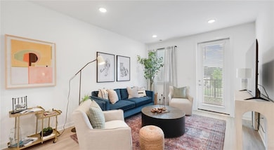 Living room with light hardwood / wood-style floor