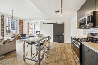 Another angle of the open kitchen and bedroom area
