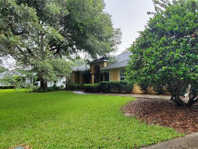 SIDE VIEW FROM DRIVE WAY TO SHOW THE MATURE LANDSC