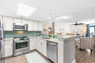 Kitchen featuring a peninsula, a sink, appliances 