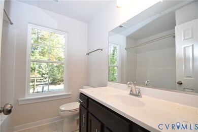 Bathroom with vanity, light tile patterned flooring, and a shower