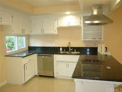 Light and bright open kitchen with granite bar top
