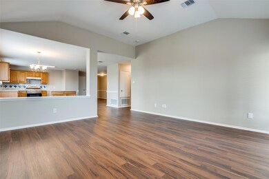 Large family room, open to kitchen and entry.  Door just past the kitchen leads into the garage.  Freshly painted, new floors--move-in ready.