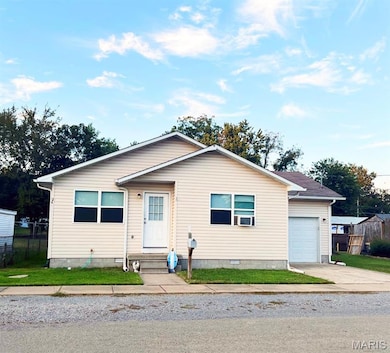 View of front of property featuring an attached garage and entry steps