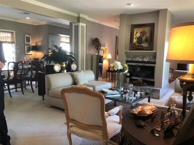 Living room featuring crown molding, a fireplace, 