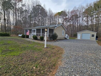 View of front of property with an outbuilding, dri