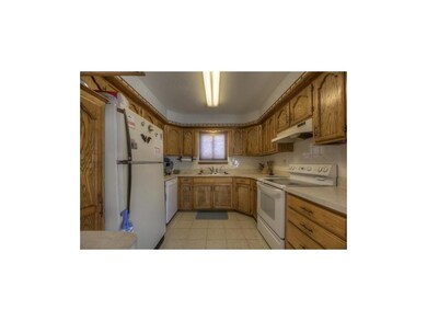 Efficient U-shaped kitchen with tile floor, tons o