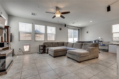 Living room with ceiling fan, light tile patterned