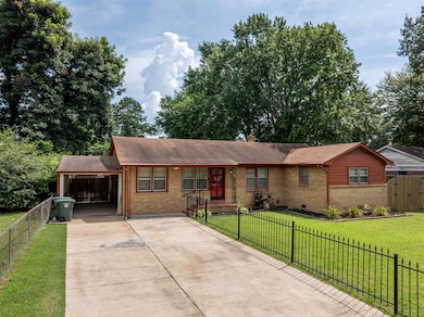 Single story home featuring brick siding, concrete driveway, a carport, and roof with shingles