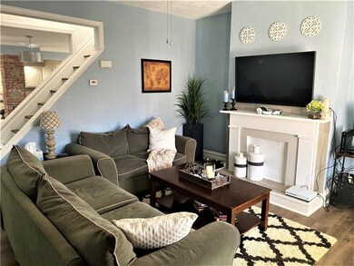 The decorative fireplace and mantel adds character