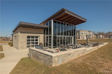 Back of house with a yard, a patio, and exterior k