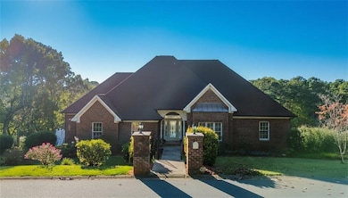 View of front of home featuring a front lawn and brick siding