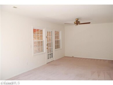 Living Room. Large living room extends across the entire back of the unit.  Door leads to patio & utility room