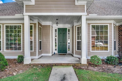 View of exterior entry with a porch