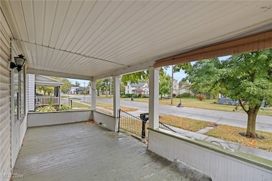 Unfurnished sunroom with a residential view and a porch