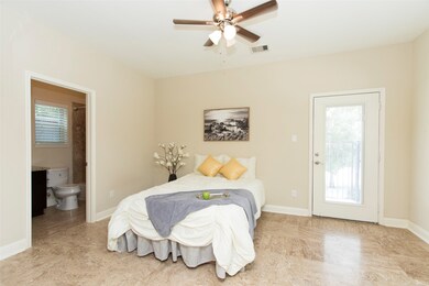 First level bedroom with travertine tile, private