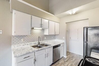 Kitchen featuring dishwasher, backsplash, black re