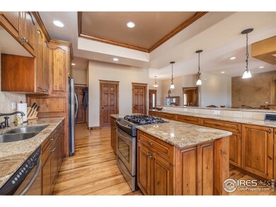 Kitchen has island plus eating bar, lots of knotty alder cabinets, abundant counter space for entertaining