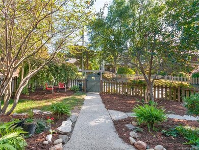 Fenced front yard with fruit trees
