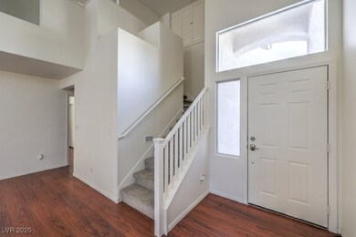 Entrance foyer featuring baseboards, a towering ce