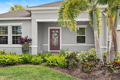 Entrance to property featuring stucco siding and roof with shingles