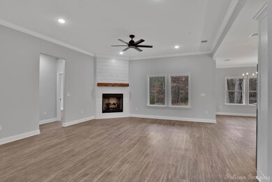 Unfurnished living room featuring ceiling fan with