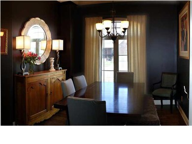 Formal Dining Room with hardwood floors, crown mol