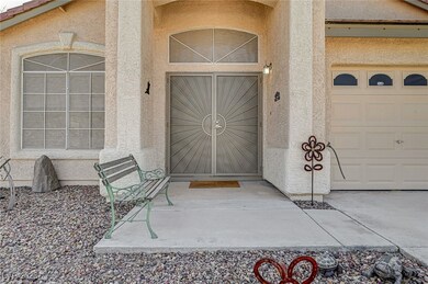 Entrance to property with a garage and stucco sidi