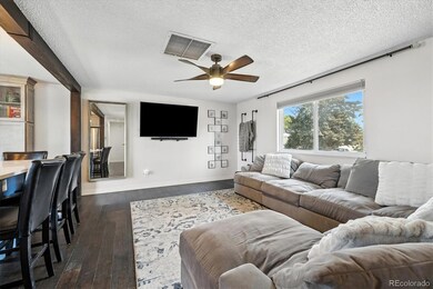 The upper floor living room has engineered wood floors, ceiling fan and views to both the north and south. The home also has both an evaporative cooler and central air conditioning.