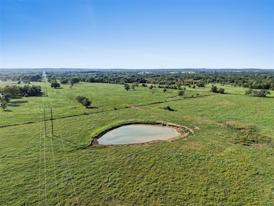 Aerial view of sparsely populated area with a large body of water and a pastoral area
