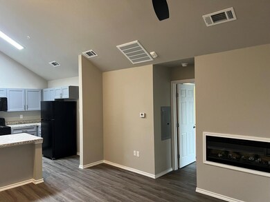 Kitchen featuring black appliances, vaulted ceilin