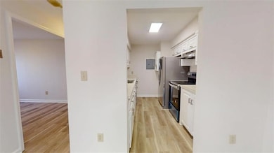 Kitchen with range with electric stovetop, light w
