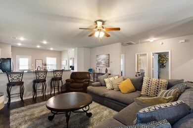 A granite-topped breakfast bar beautifully separates the family room and kitchen, where you can add your bar stools for additional seating.
