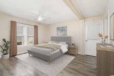 Bedroom featuring ceiling fan, baseboards, and woo