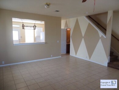 Living Area: Cut-outs open the kitchen to the livi