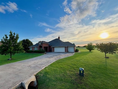 Single story home with a front yard, an attached garage, driveway, and brick siding