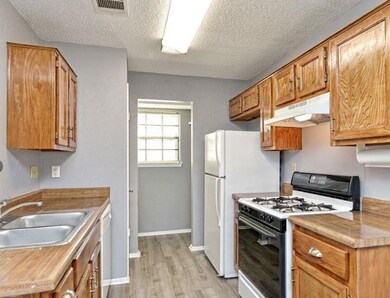 Kitchen with white appliances, under cabinet rang