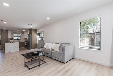 Living area with baseboards, visible vents, light