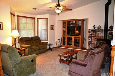 The inviting living room has a soaring vaulted cei