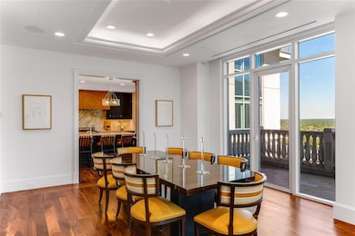 Dining room featuring a tray ceiling, indoor wet b