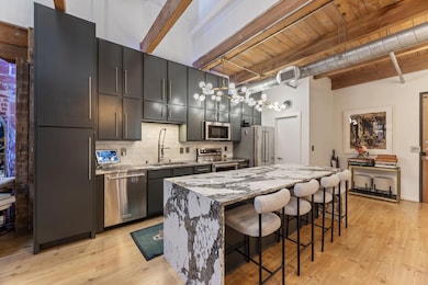 Kitchen with a sink, stainless steel appliances, b