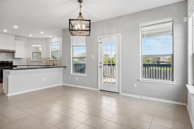 Kitchen featuring electric range, dark countertop