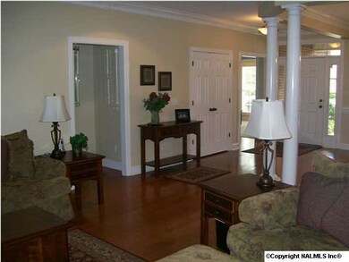 The view of the open floor plan looking from the great room to the front foyer, formal dining room, and main level study.