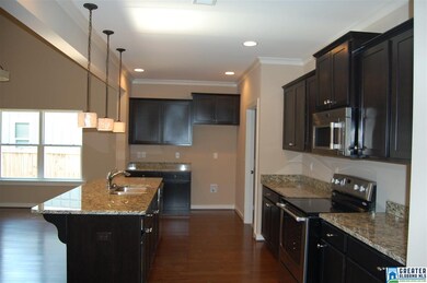 Large kitchen island with beautiful pendant lighti